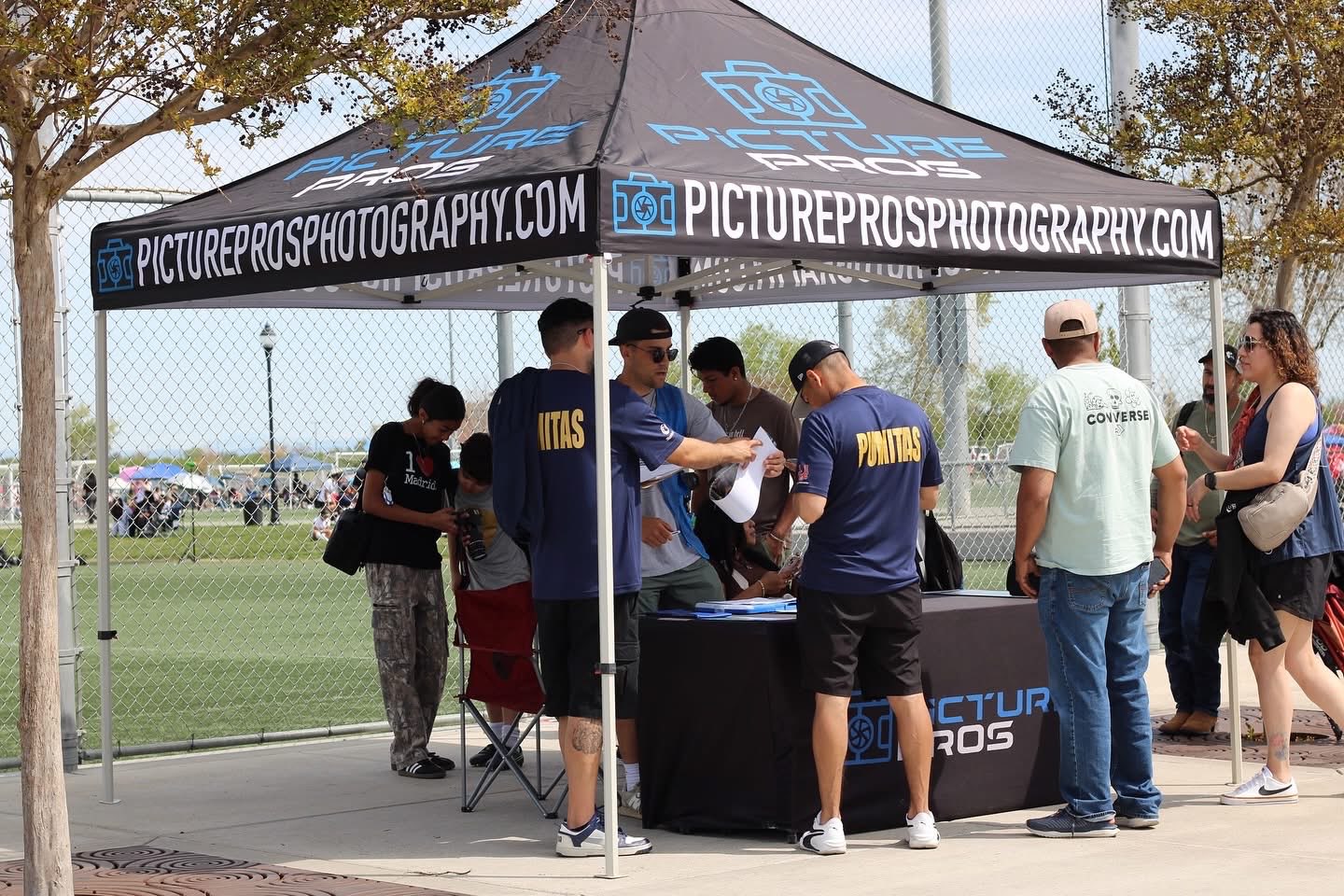 Families visiting the Picture Pros booth at a tournament